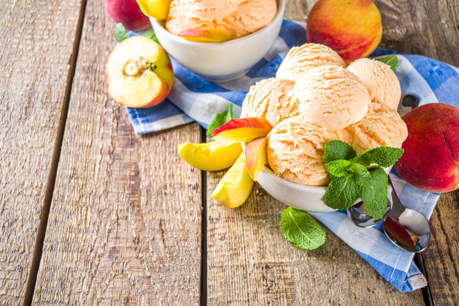 Peach Ice Cream in a Bowl with Mint on Table